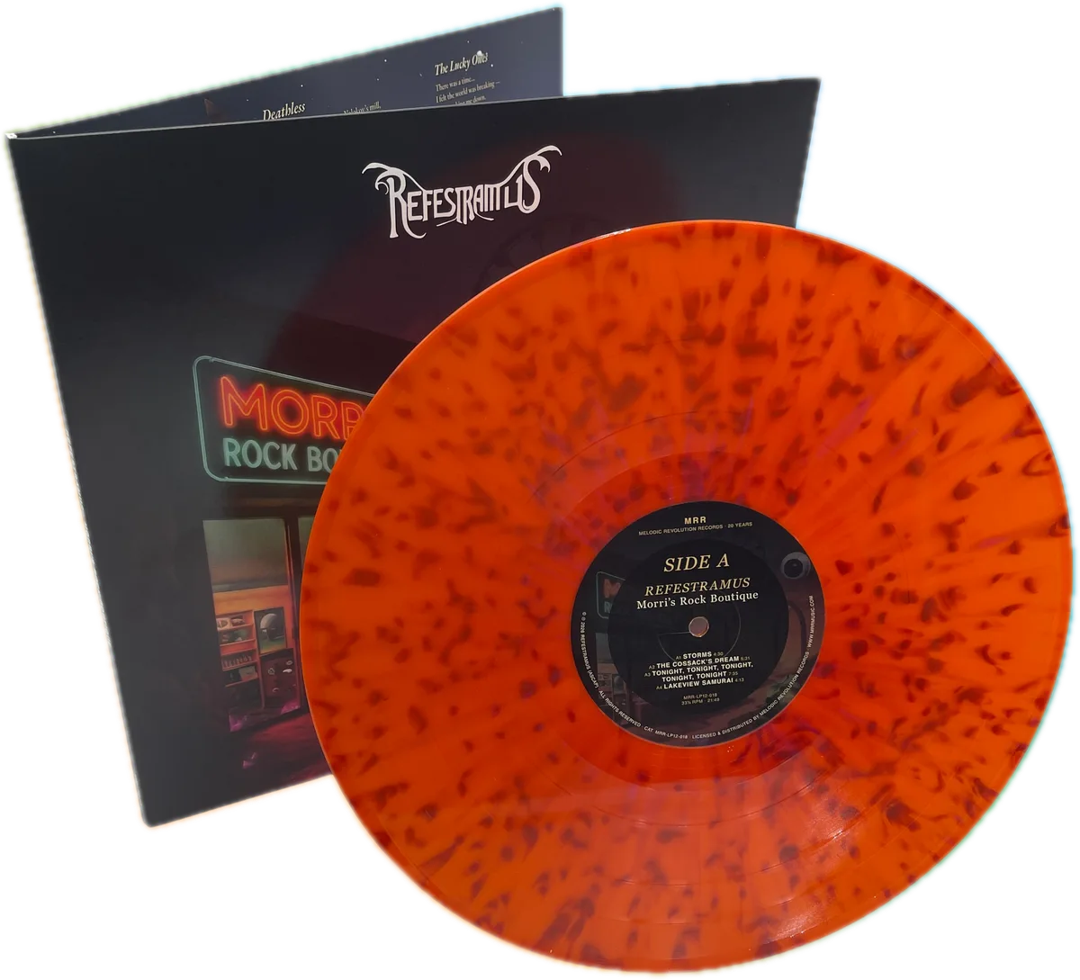 The orange splatter vinyl disc, side A label showing, in front of the sleeve